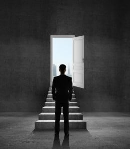 man-looking-through-open-door
