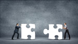 people-pushing-giant-puzzle-pieces