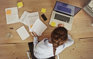 busy-woman-working-at-messy-desk