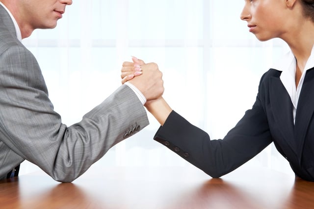 business man woman compete competition arm wrestle.jpg