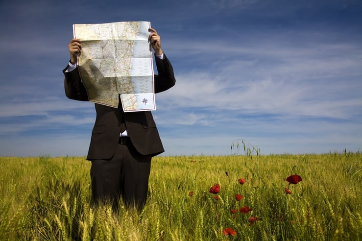 man lost with map in field